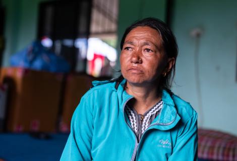 Dawasang at a holding centre in Tupche, Nepal. She lost her husband in the floods and worries about her children’s future.